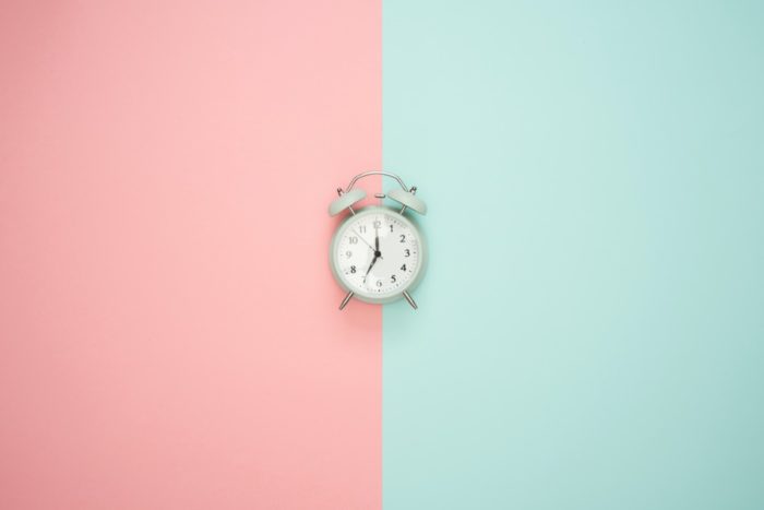 A clock on a multi-coloured wall